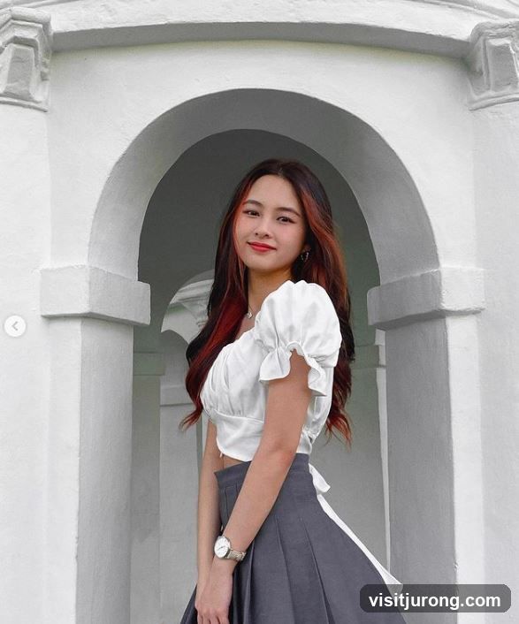 Young woman posing in white archway
