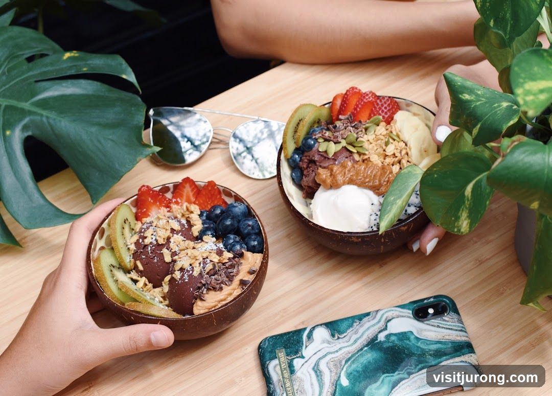 Two smoothie bowls with fruit and granola