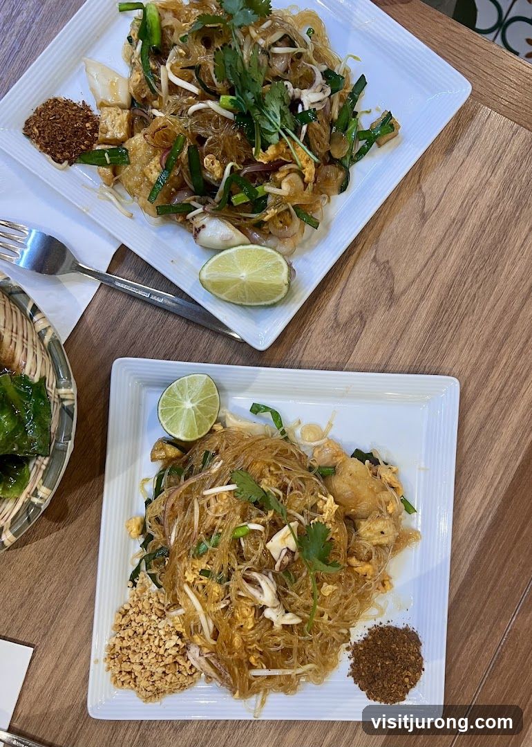 Two plates of Pad Thai noodles