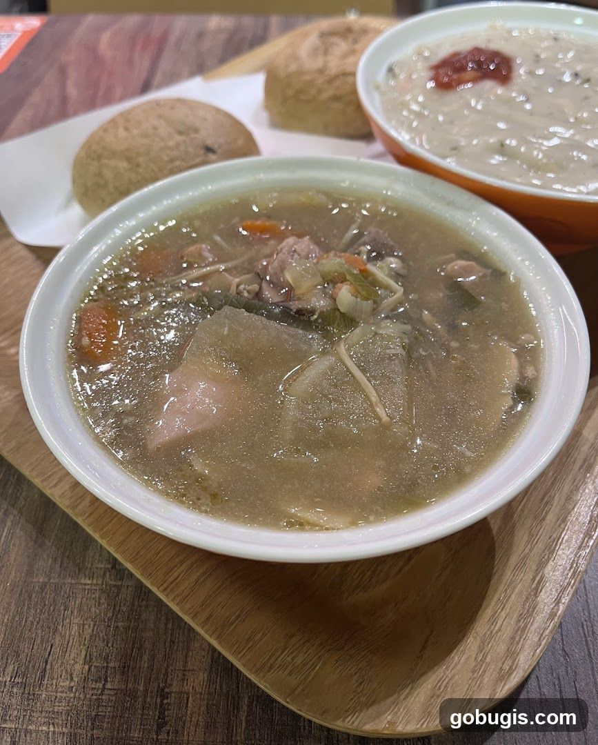 Two bowls of soup with bread