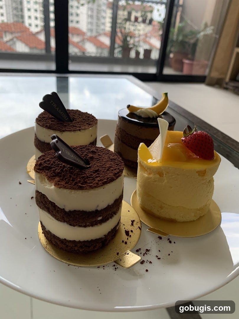 Four Small Cakes on a White Plate