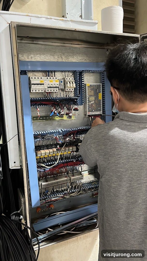 Electrician working on control panel