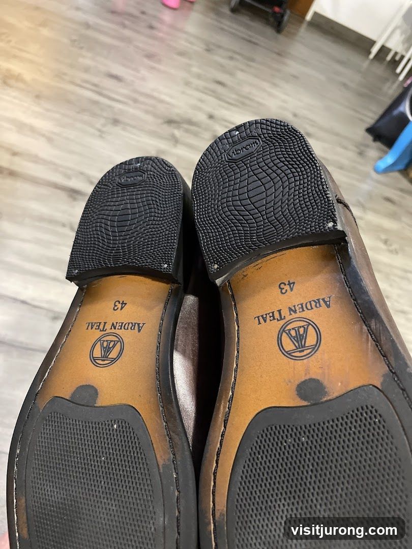 Bottoms of two brown leather shoes