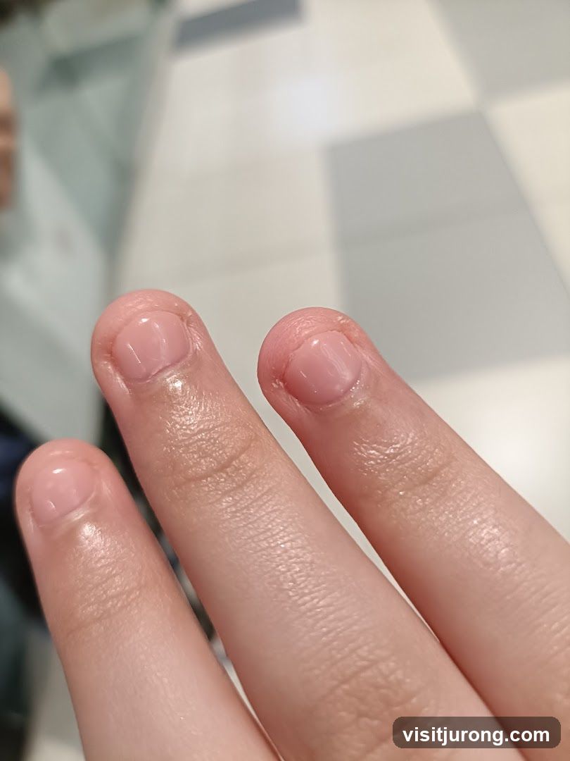 Close-up of fingers with light pink nail polish