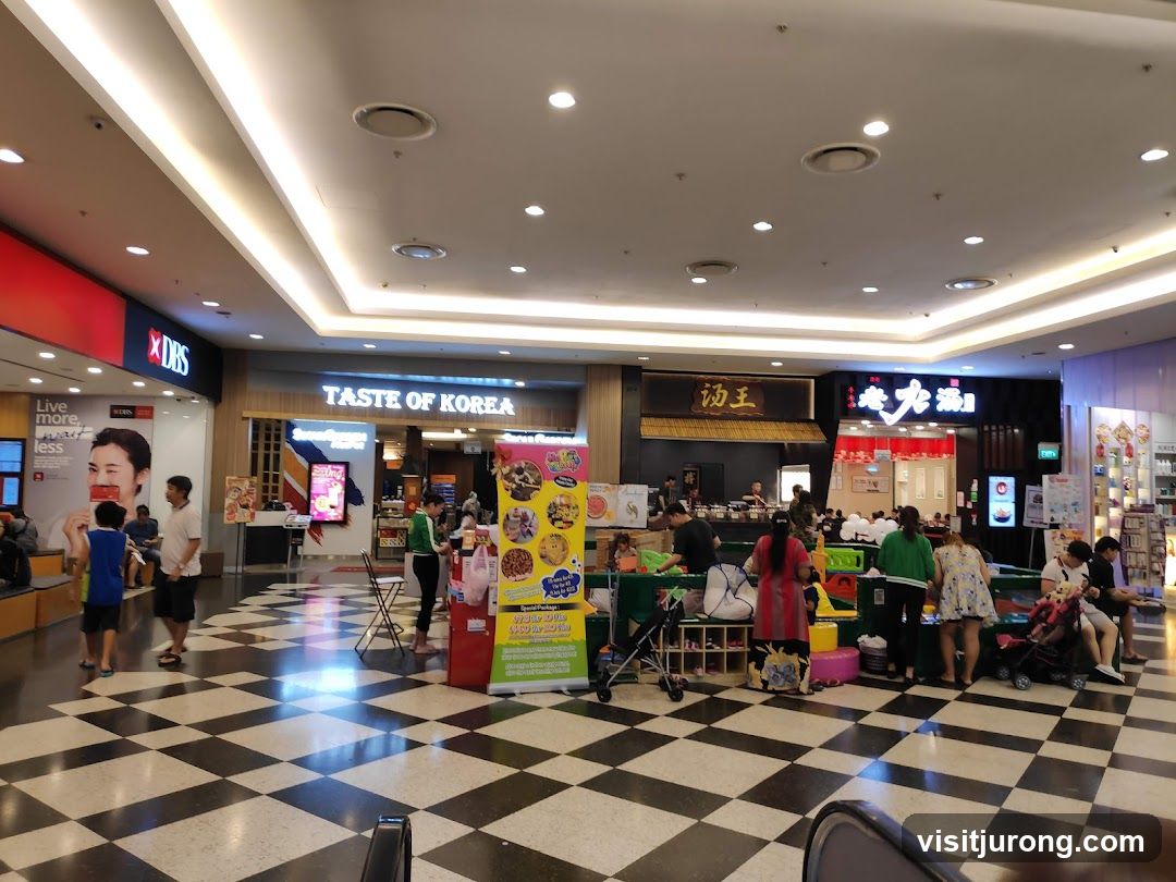 Indoor shopping mall with various food stalls and shops