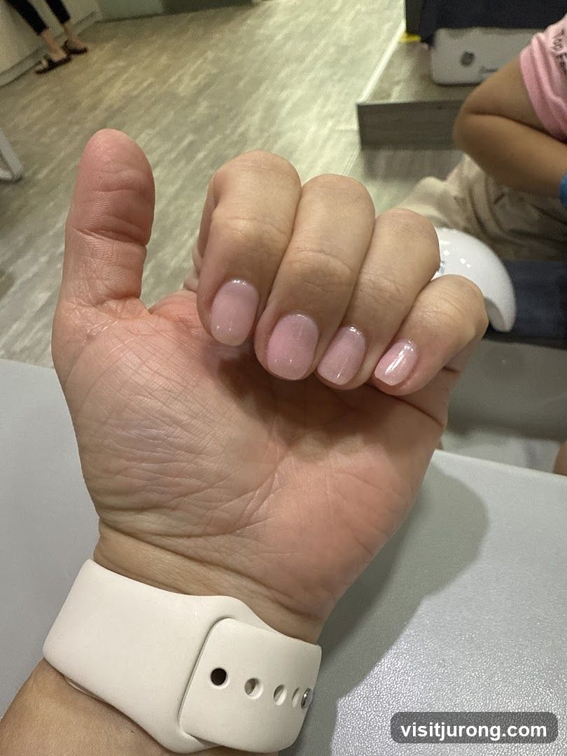 Manicured Hand with Light Pink Polish