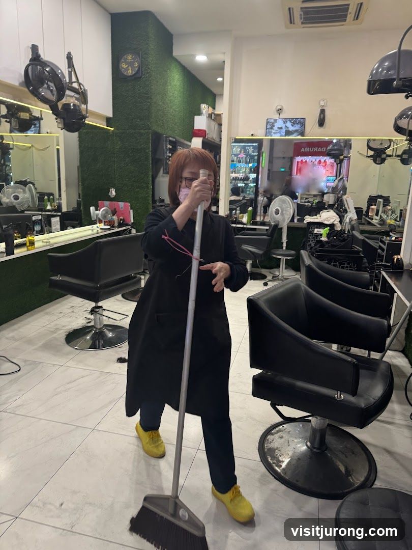 Hairdresser sweeping floor