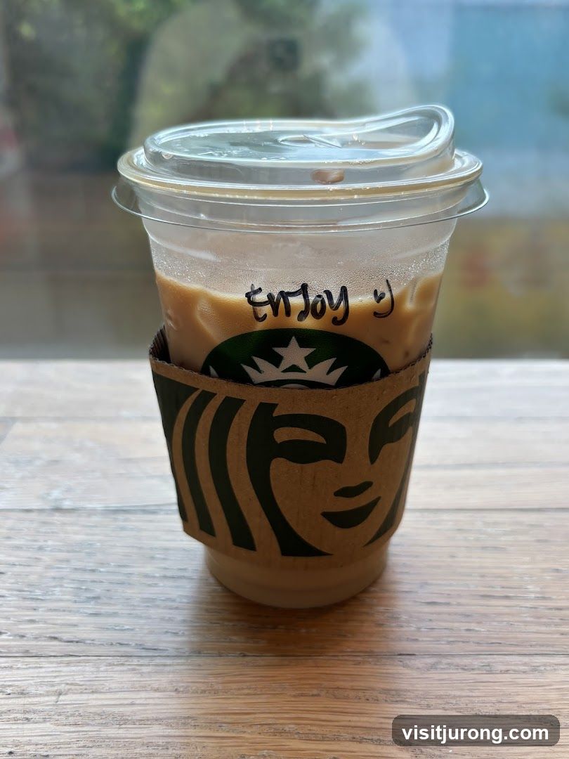 Iced Coffee with "Enjoy :)" written on cup