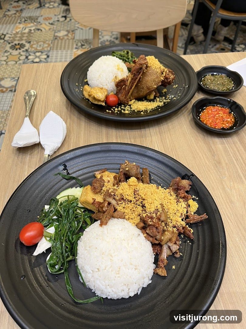 Two plates of rice with fried meat and vegetables
