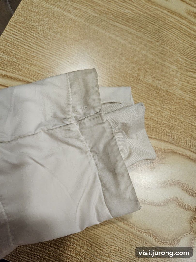 Close-up of a light-colored garment with a stained collar