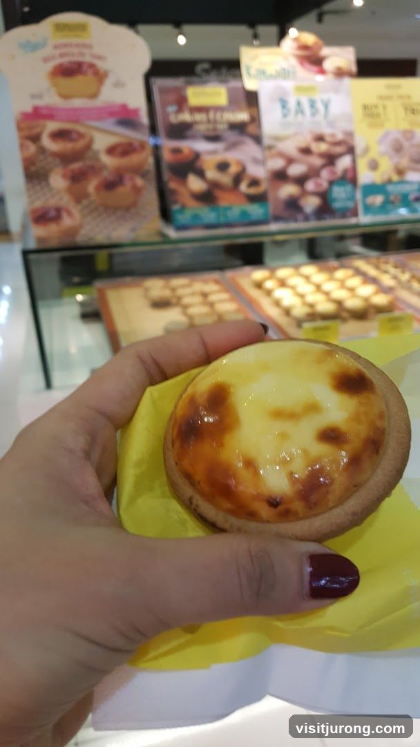 Hand holding a cheese tart