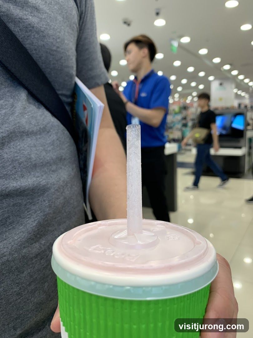 Person holding a drink in a store