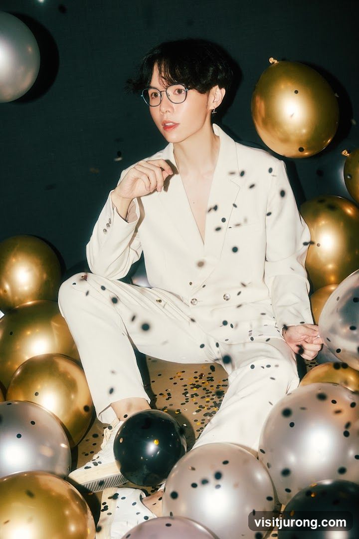 Man in a suit surrounded by balloons