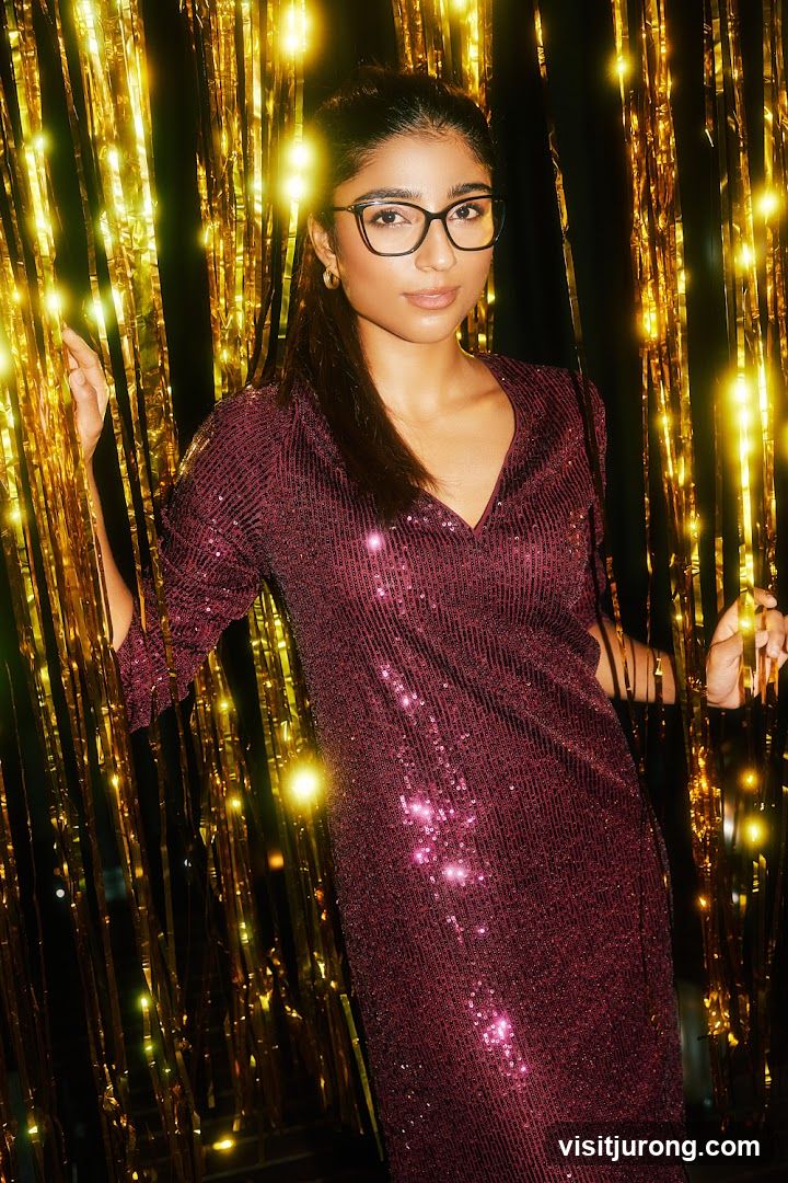 Woman in sequined dress and glasses