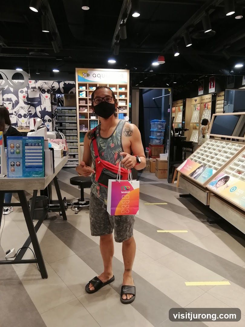 Man holding a shopping bag in an optical store