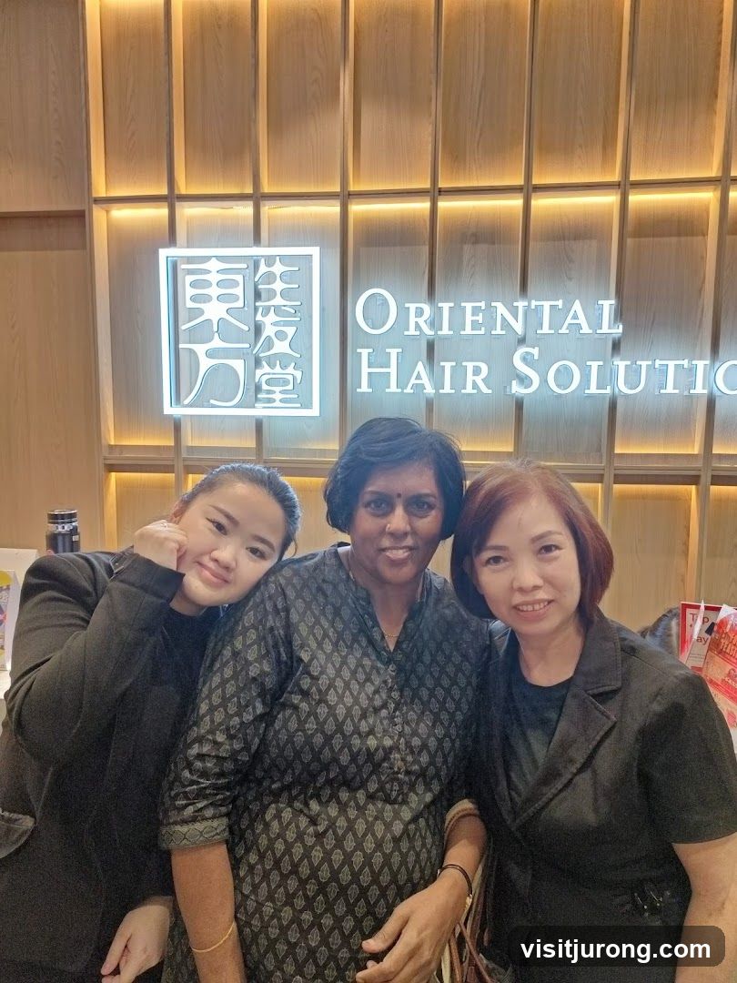 Three Women Posing in Front of a Salon Sign
