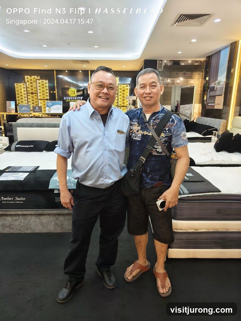 Two men posing in a mattress store