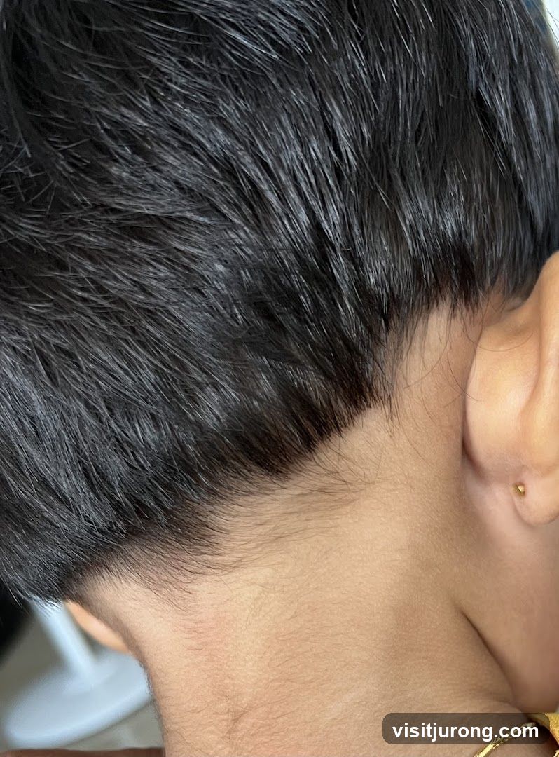 Close-up of a person's neck and ear