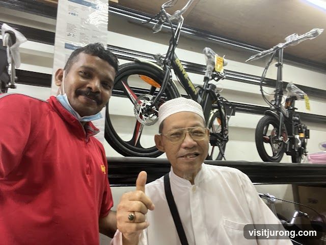 Two Men Posing with Bicycles