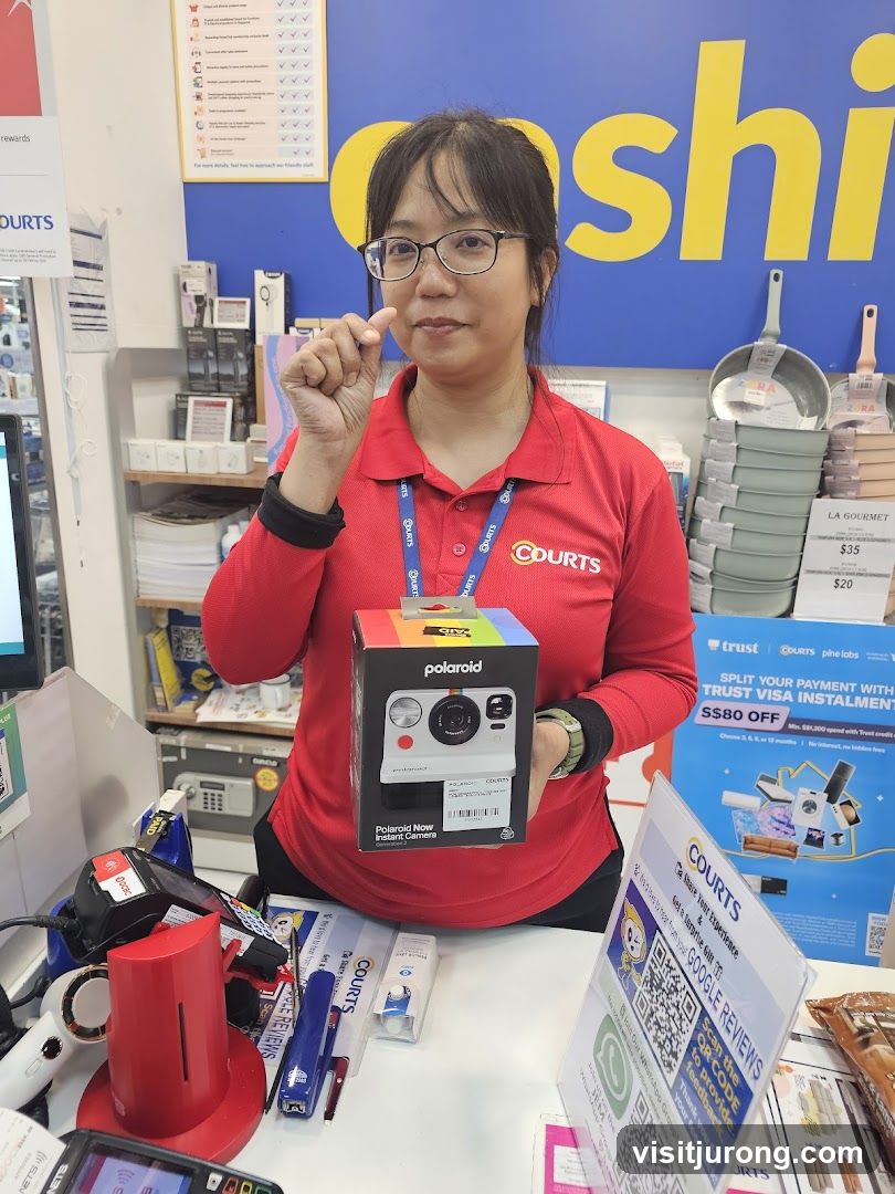 Employee holding a Polaroid camera