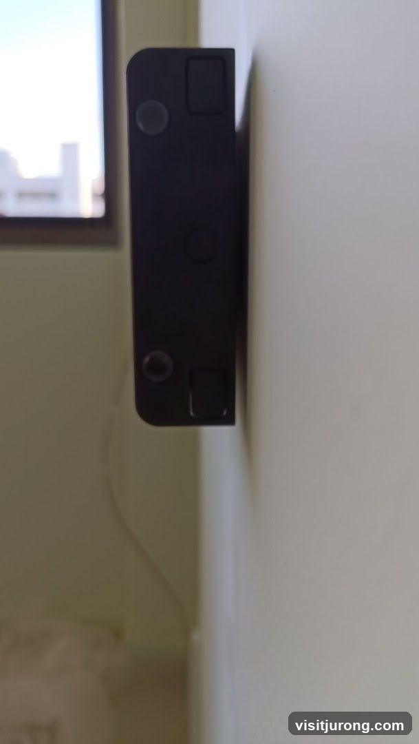 Black electronic device mounted on a wall