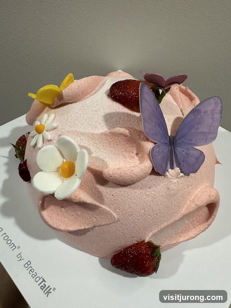 Pink Frosted Cake with Strawberries and Butterflies