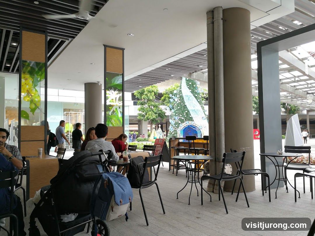 Outdoor cafe seating with Christmas tree in background