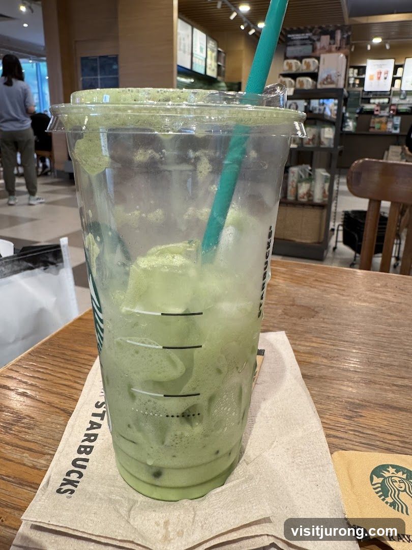 Half-empty matcha drink in a Starbucks cup