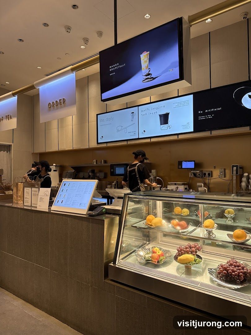 Tea shop interior with digital menus and fruit display
