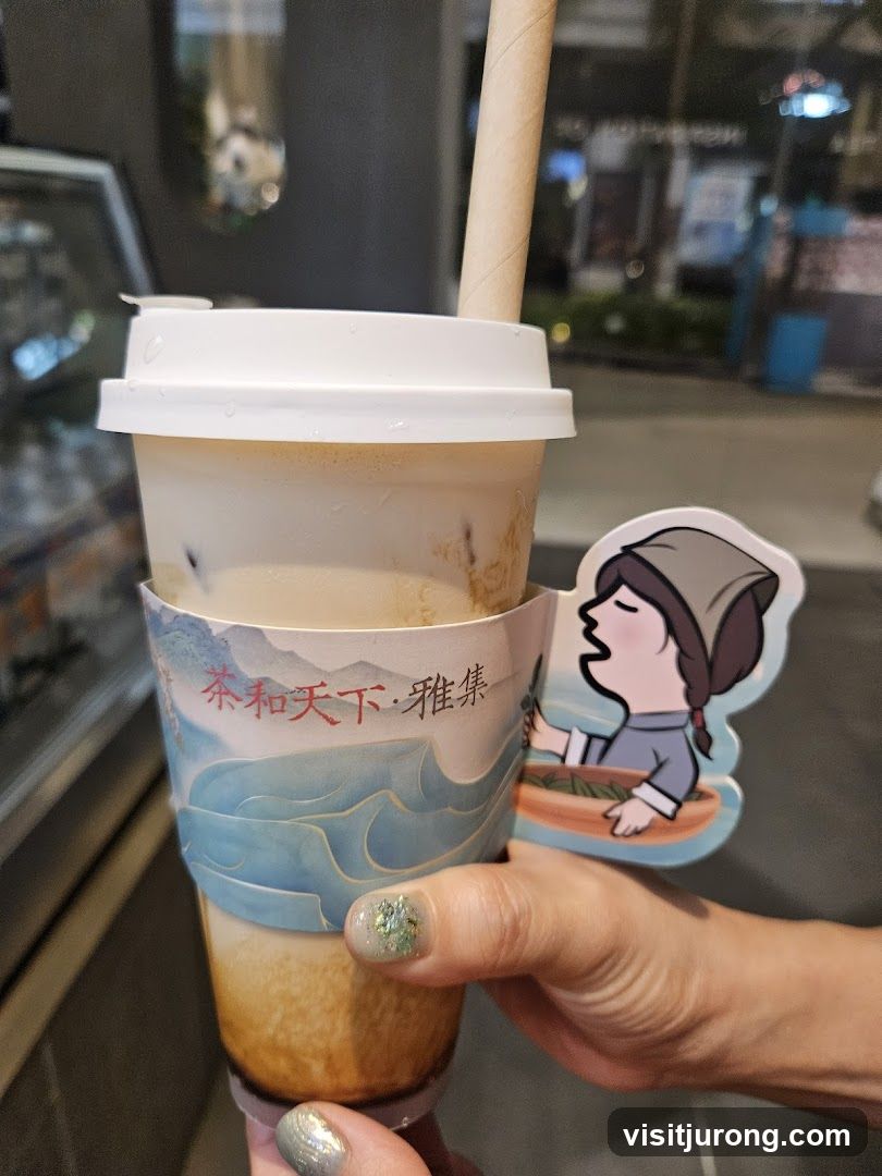 Hand holding a bubble tea with decorative sleeve