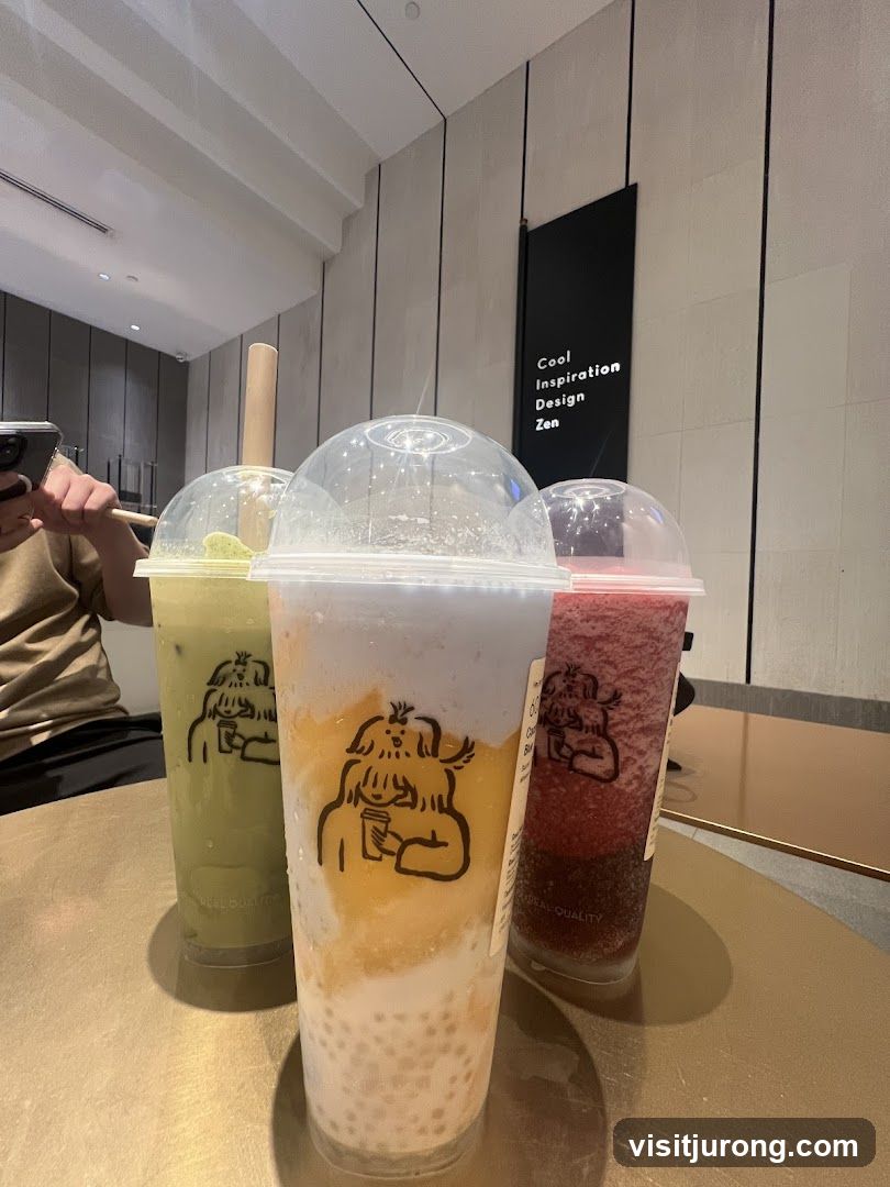 Three colorful drinks with cartoon logo
