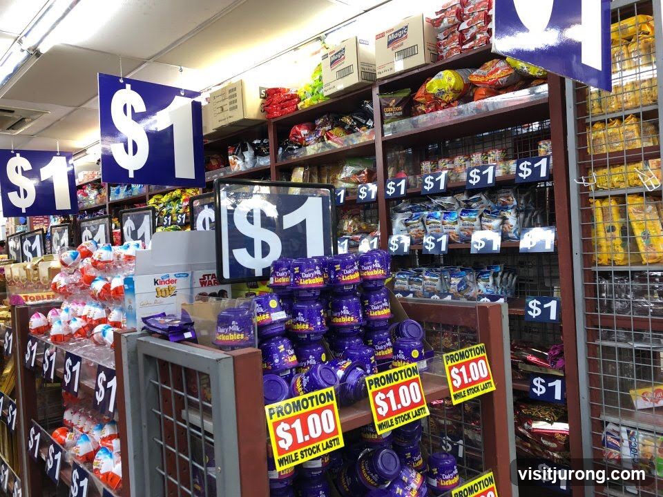 Candy and snack aisle with $1 price signs