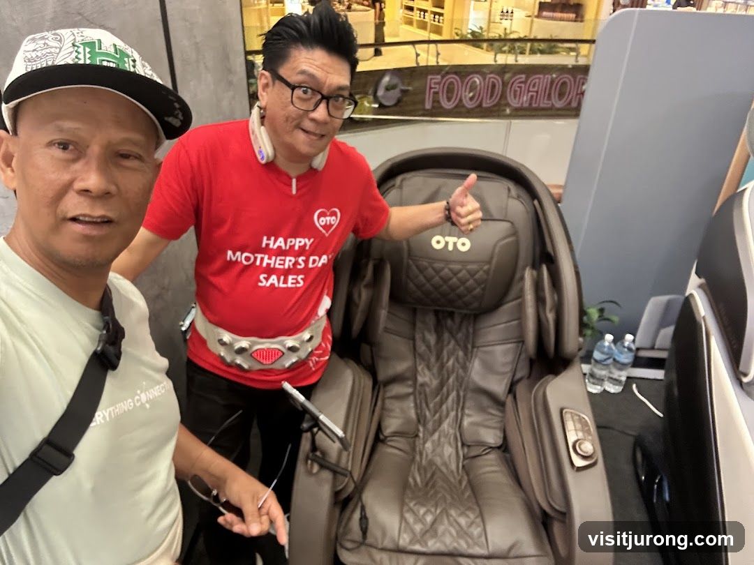 Two men posing with a massage chair