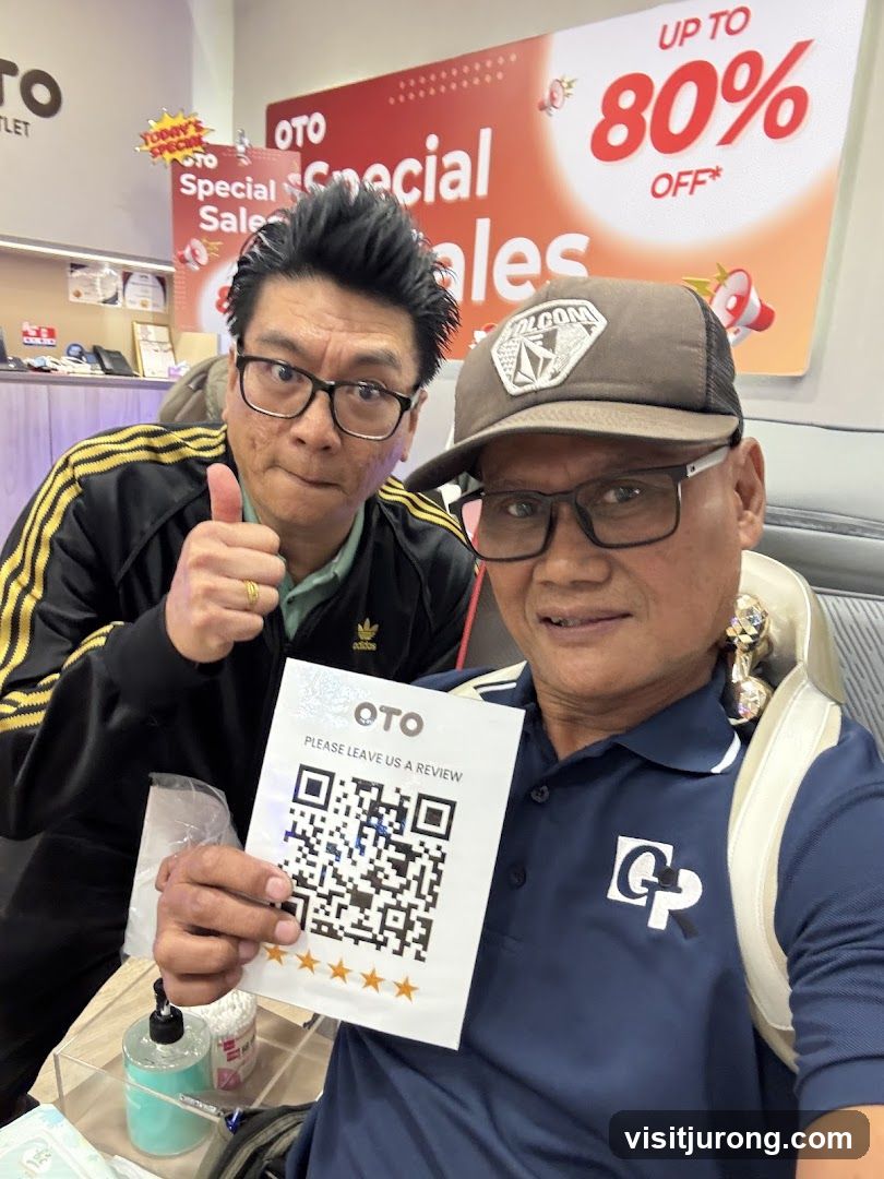 Two men posing with a review QR code