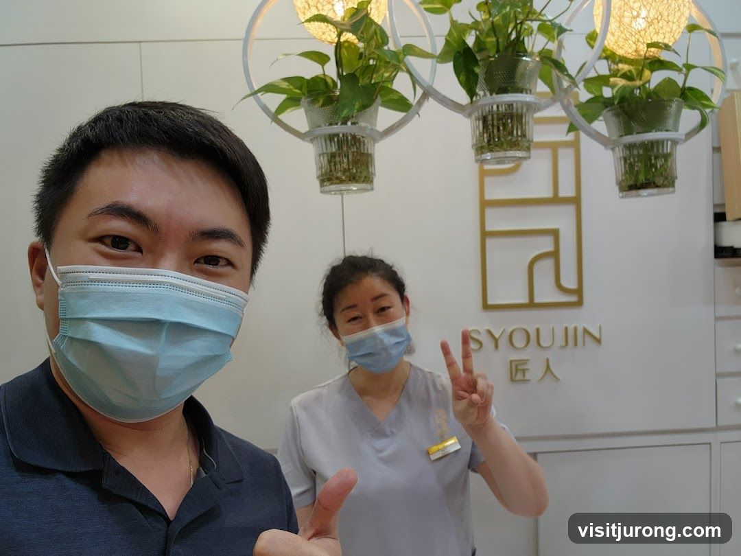 Two people in a room with plants and a sign