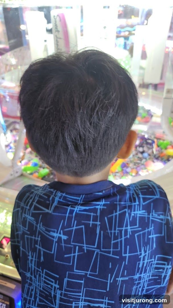 Child looking at claw machine