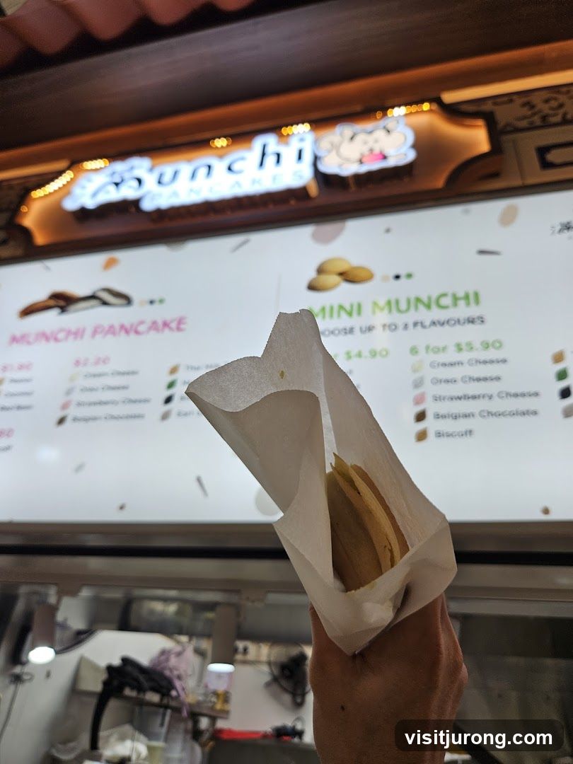Pancakes being held in front of a menu