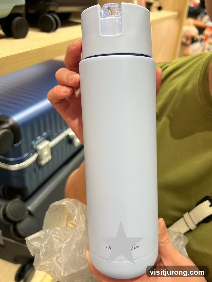 Person holding a light blue water bottle