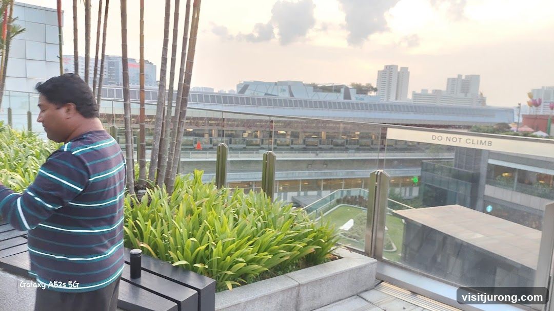 Man on a balcony overlooking a city