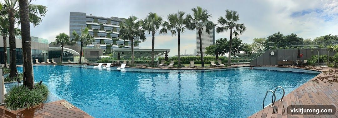 Swimming Pool with Palm Trees and Hotel