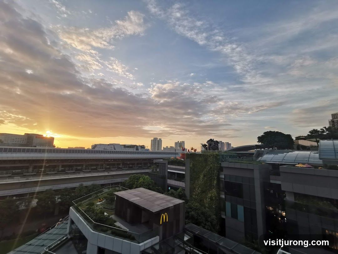 Sunset over a cityscape with a McDonald's sign