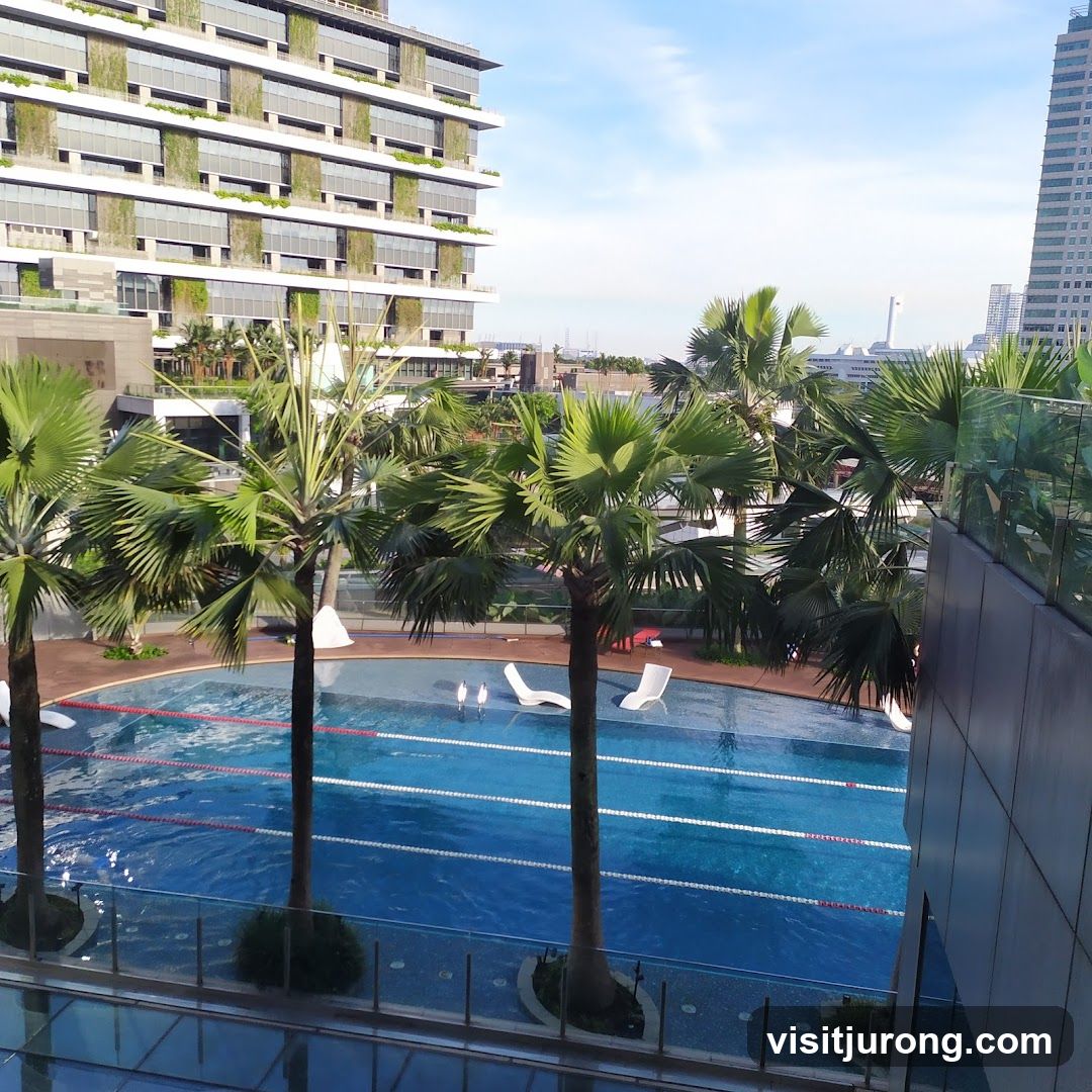 Swimming Pool with Palm Trees and Modern Buildings