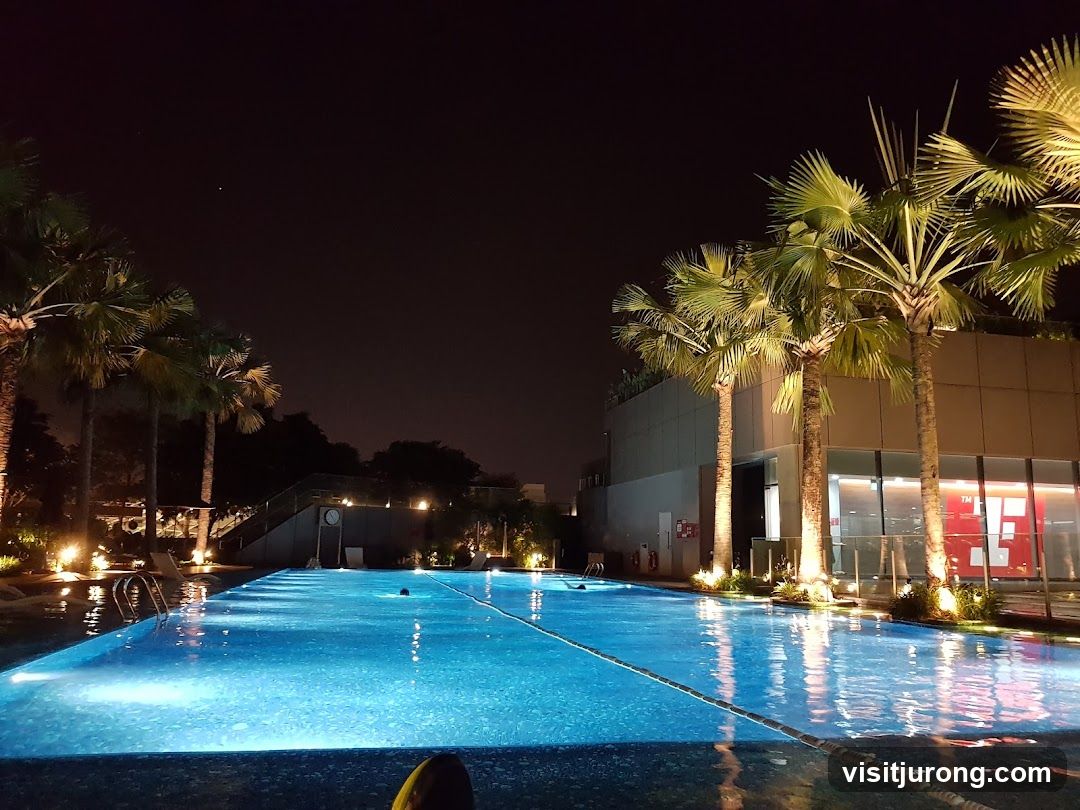 Nighttime Swimming Pool with Palm Trees