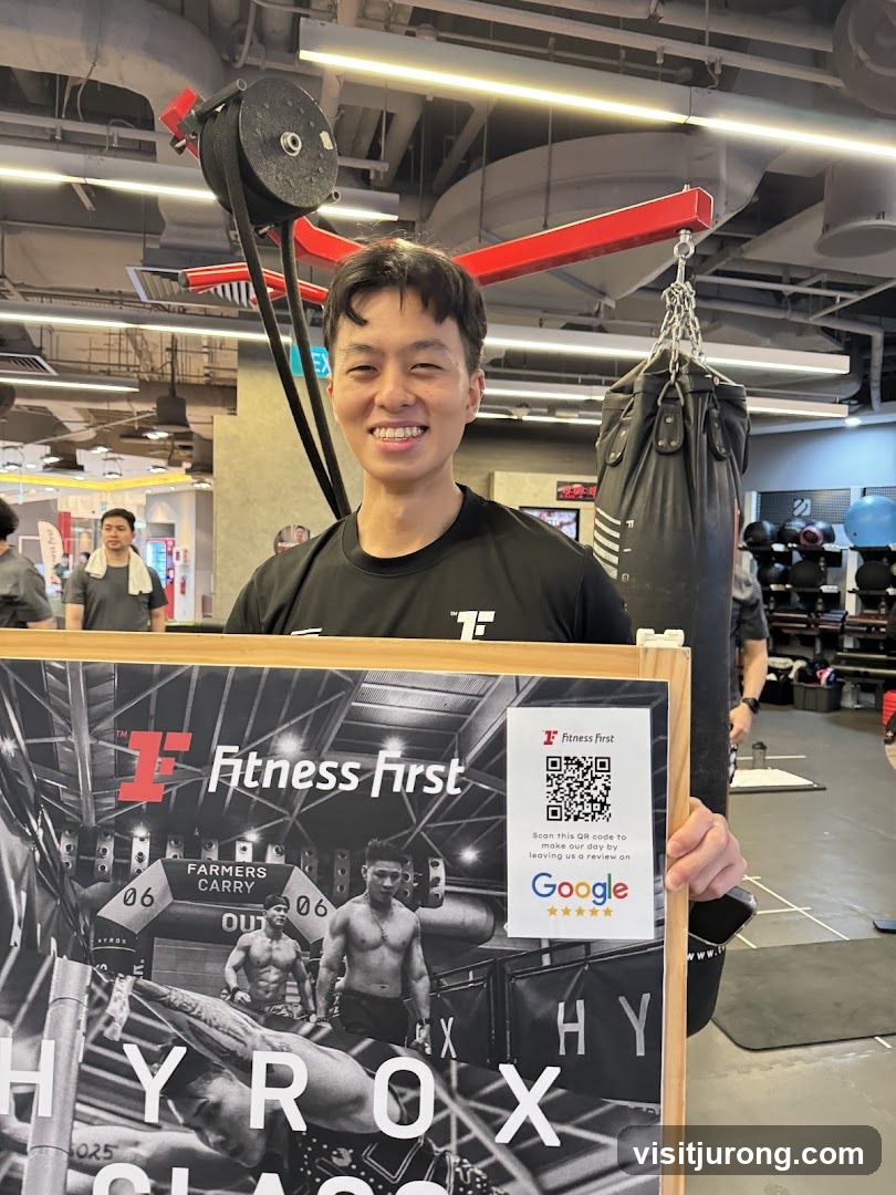 Fitness First Instructor with Promotional Poster