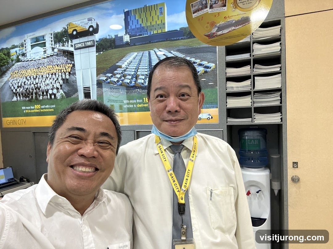Two Men in Front of a Company Mural