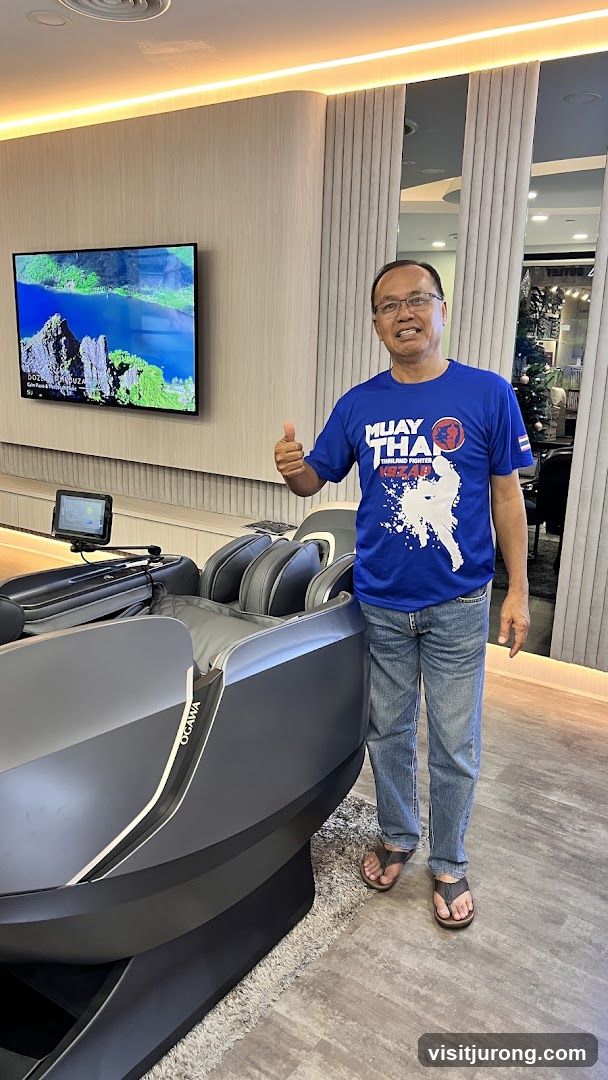Man giving a thumbs up next to a massage chair