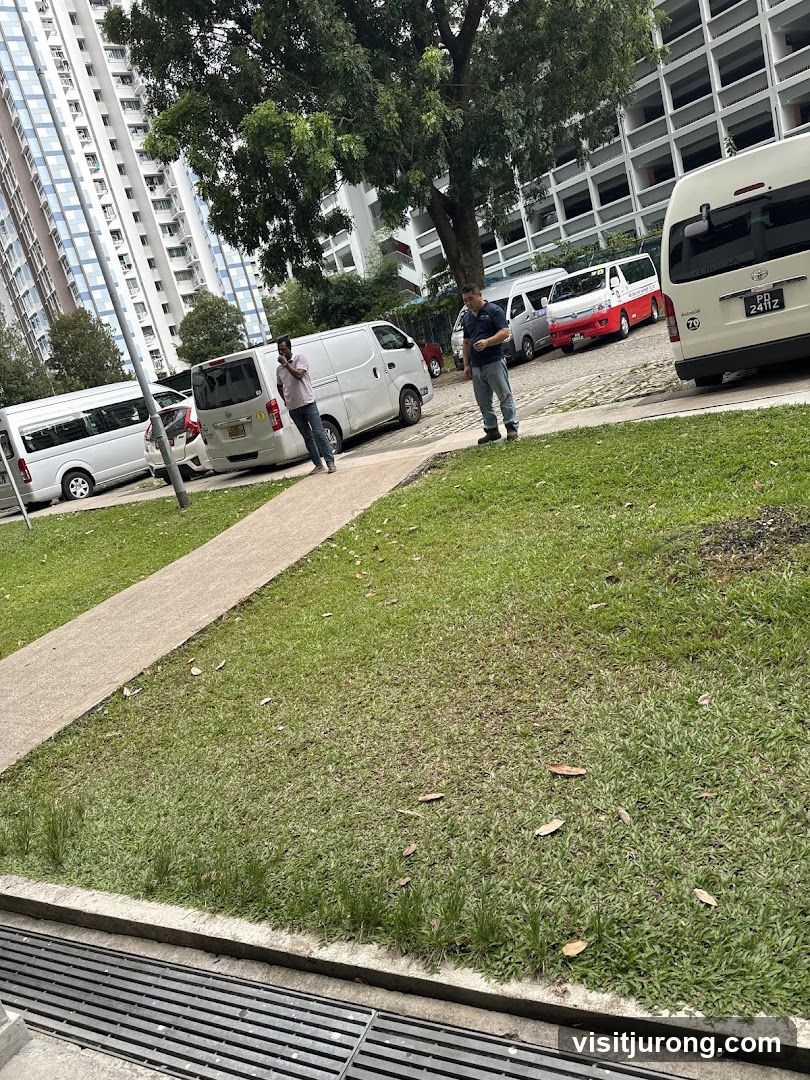 Two men standing near parked vans