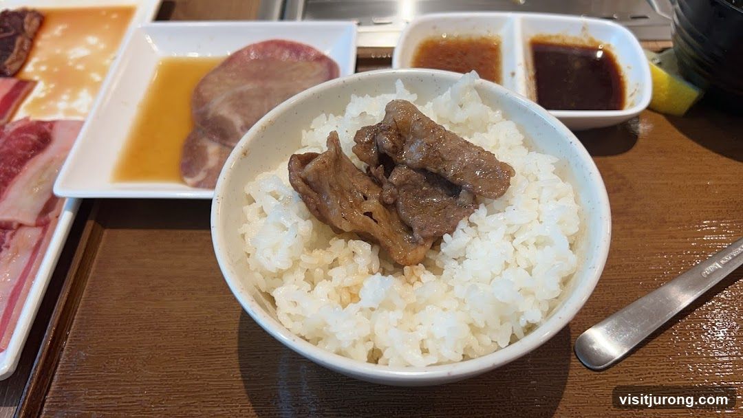 Bowl of rice with meat and side dishes