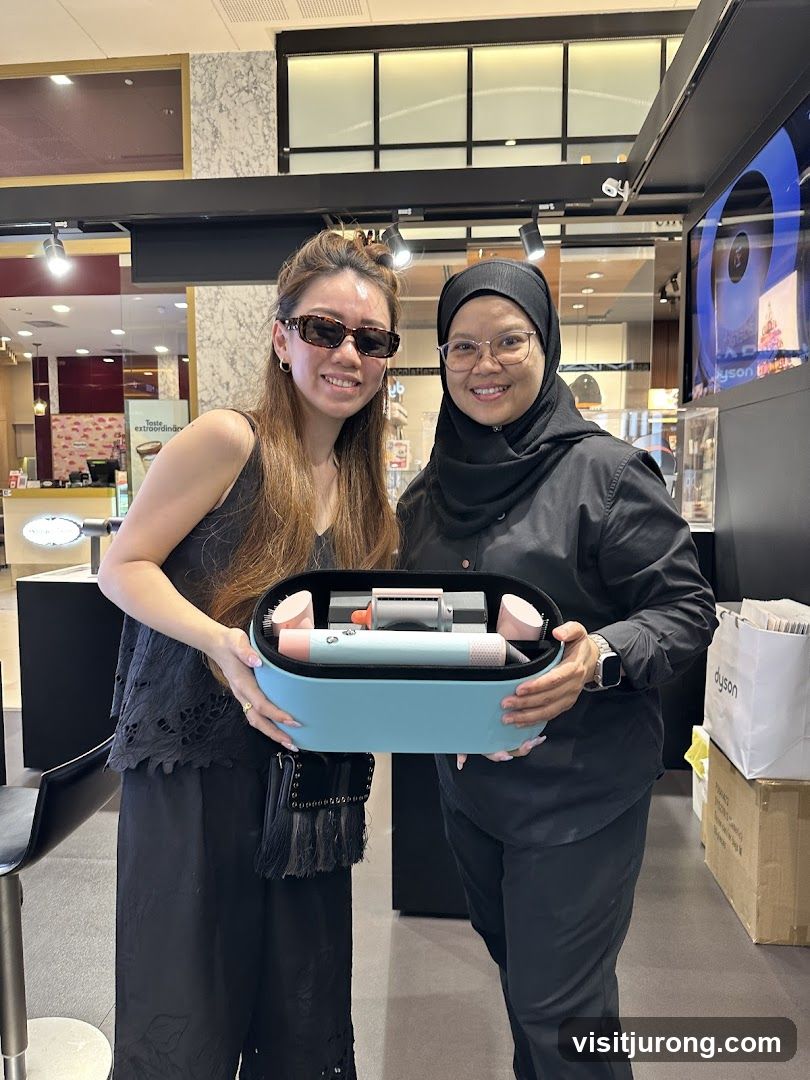Two Women Holding a Dyson Hair Styler