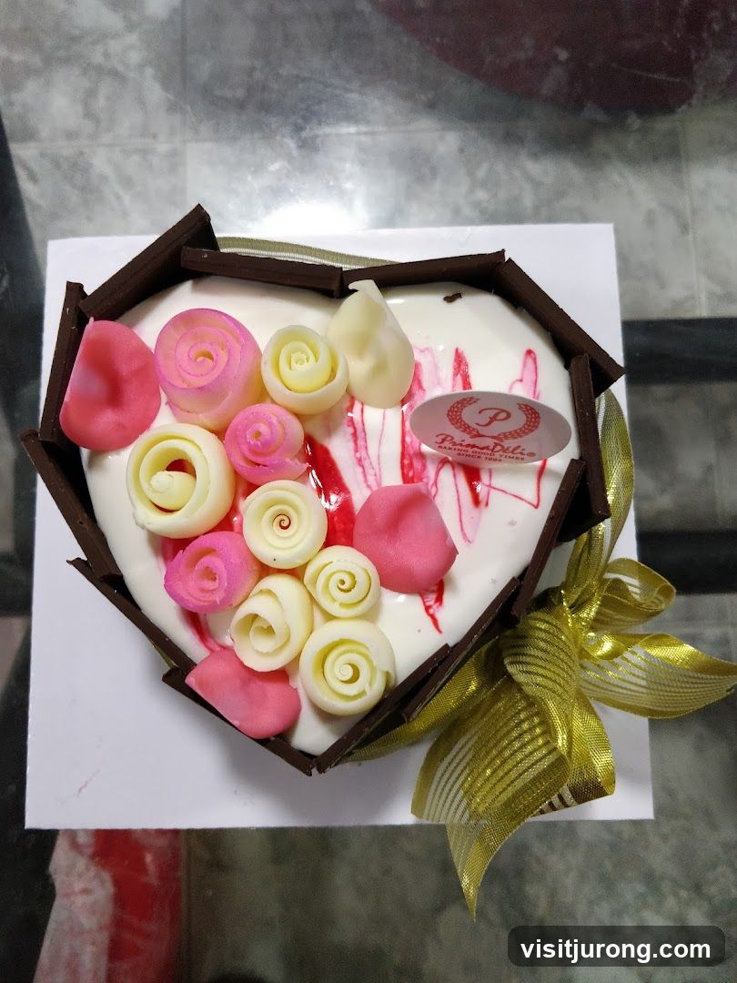 Heart-shaped cake with chocolate and frosting decorations